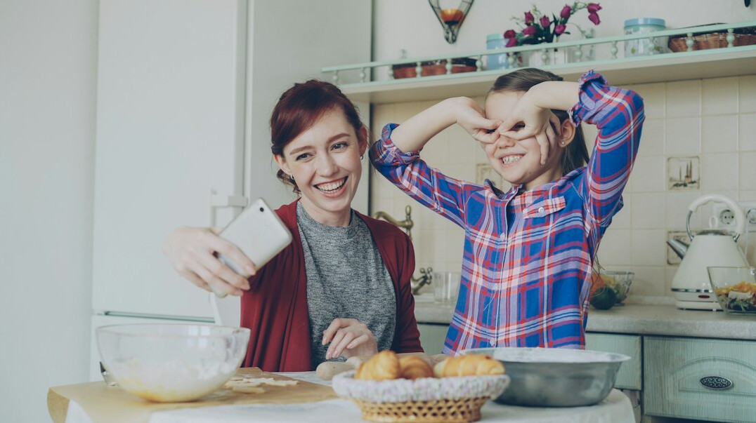 Danish family reviewing household bills together at the kitchen table